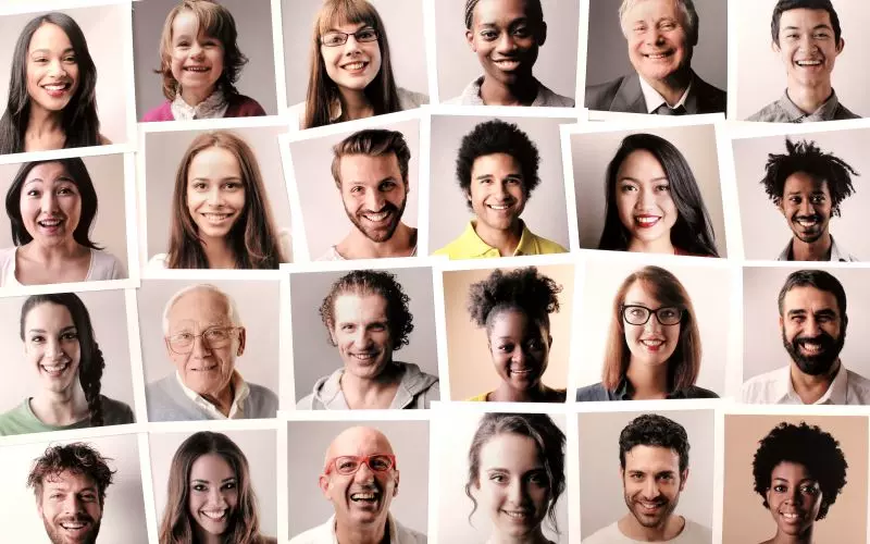 A grid of smiling faces of many different people