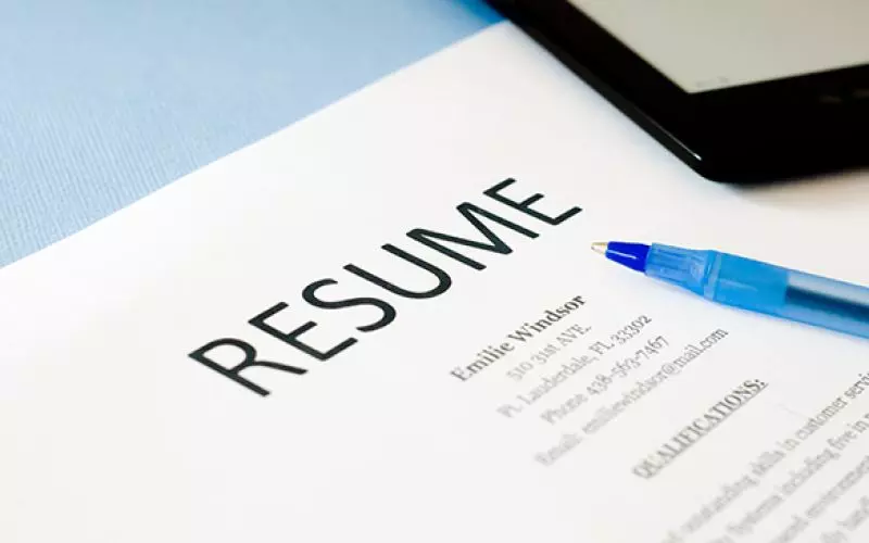 A sheet headed Resume beside a blue pen