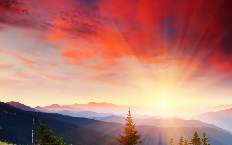 Sunrise over a wide mountain range
