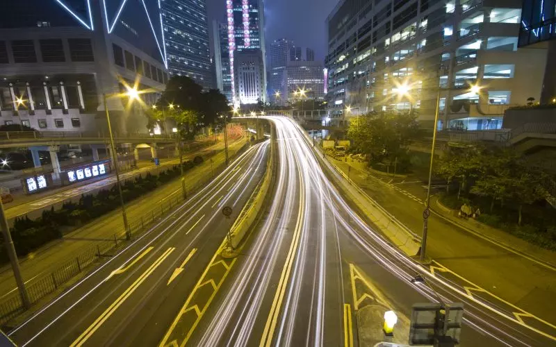 Light trails from traffic on a city road at night