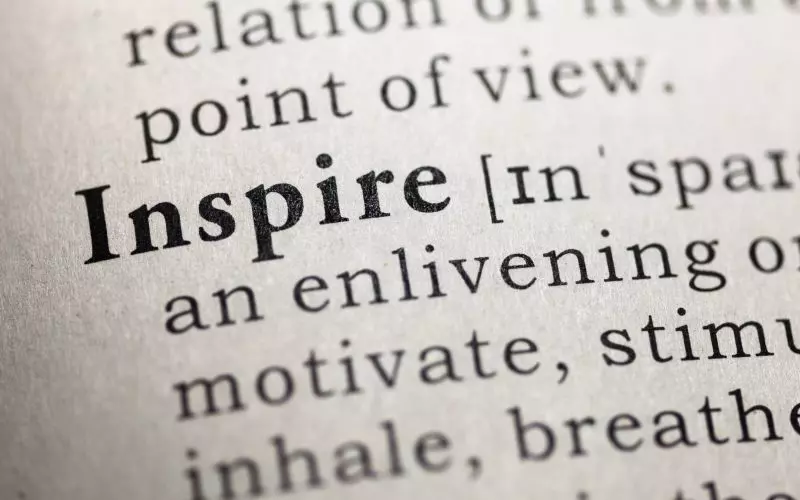 Close-up of dictionary type with the word Inspire in bold