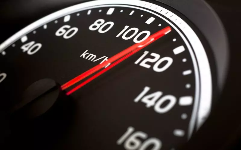 A speedometer with the needle sweeping past the midpoint