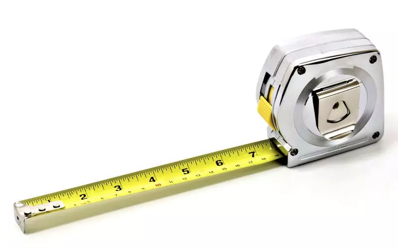 A yellow tape measure pulled out from its case