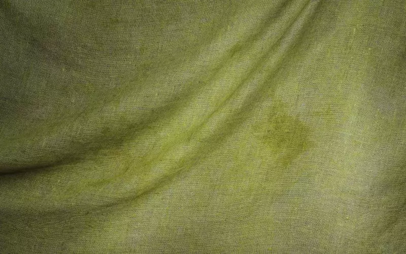 An evenly lit olive linen texture