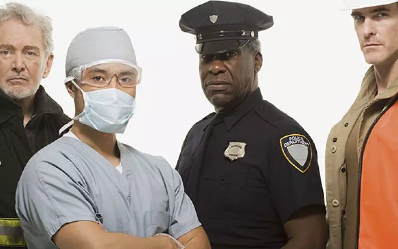 A row of people in medical, police and service uniforms