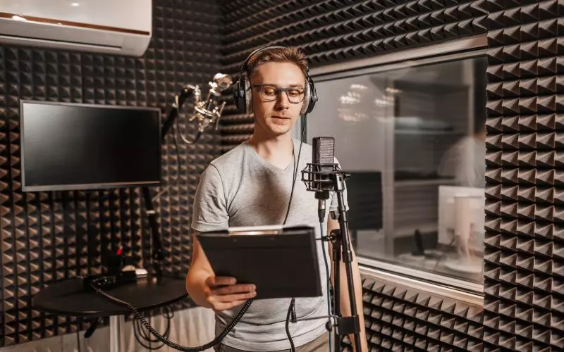 A man recording in a sound treated booth