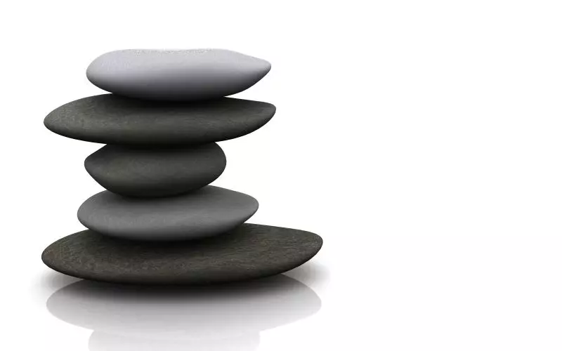 A stack of smooth black stones in balance