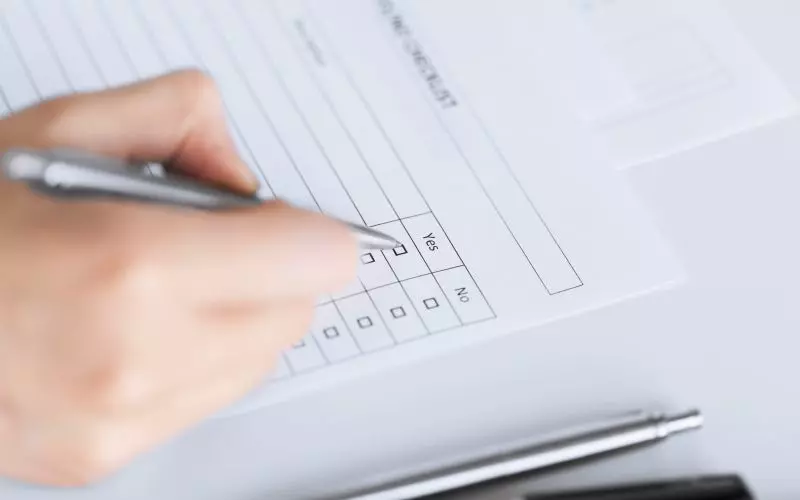 A hand ticking items off a checklist