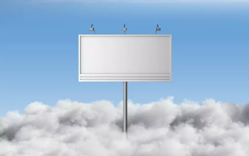 A blank billboard standing above the clouds