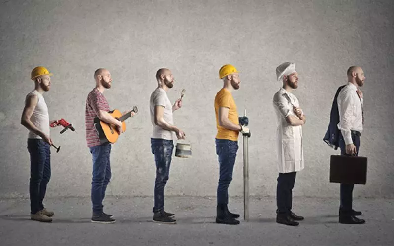 A line of people dressed for many different professions