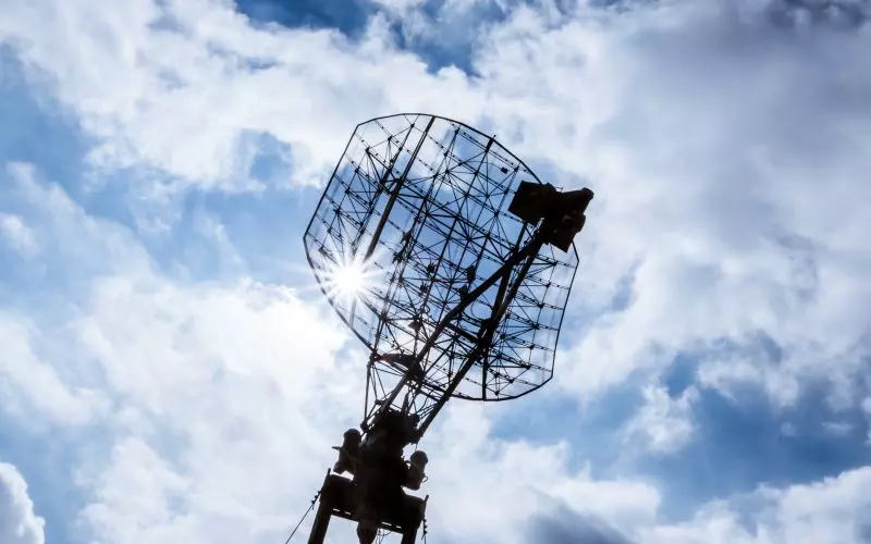 A satellite dish against a blue sky