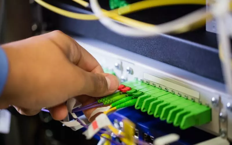 Colored network cables being connected to a panel