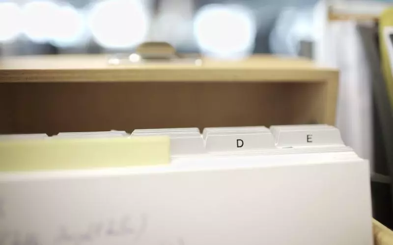 An open filing drawer with labeled dividers