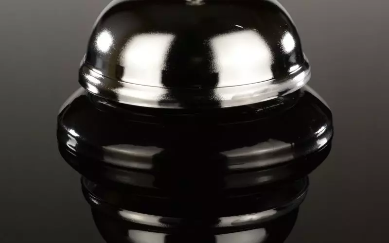 A single service bell on a dark surface