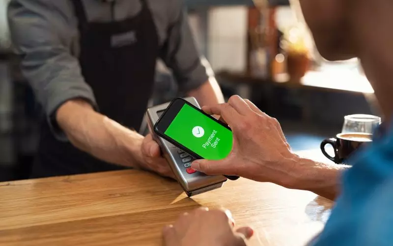 Hands working a phone screen on a table