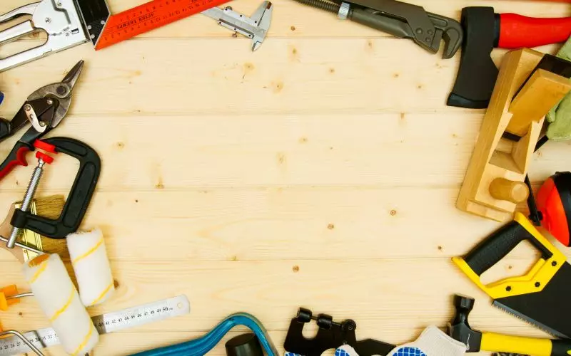 Woodworking tools laid out on fresh pine