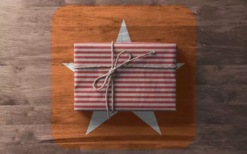 A wrapped gift with a star decoration on wood