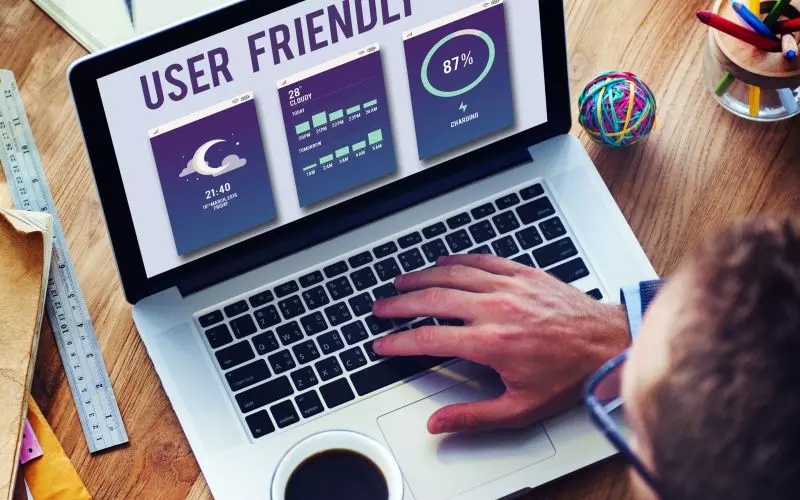 Hands on a laptop showing user friendly interface designs