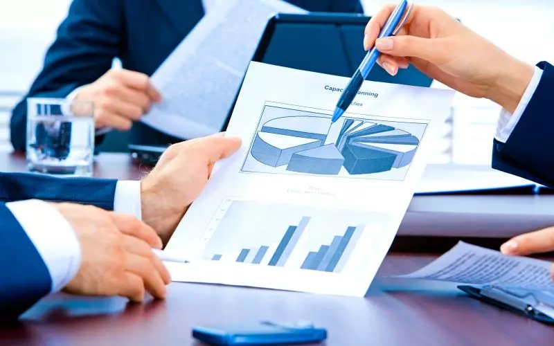 A team reviewing charts together at a meeting table
