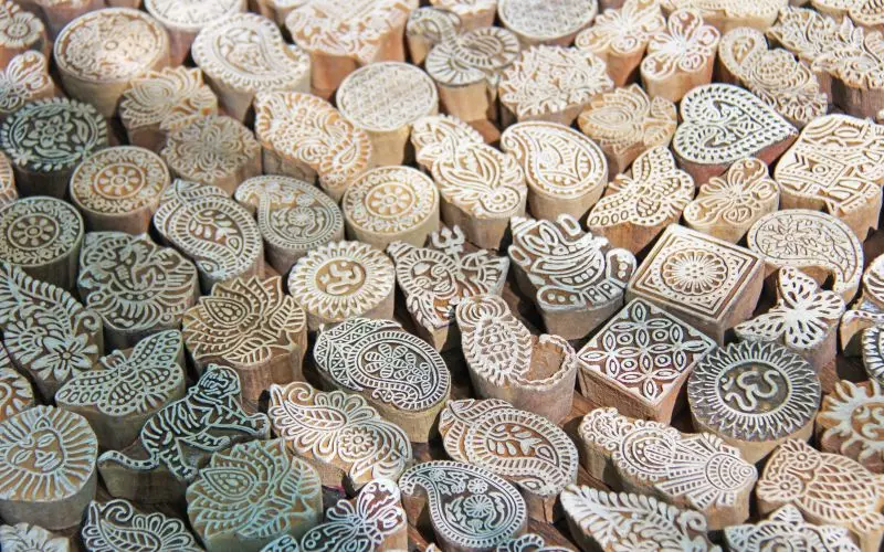 Dozens of carved wooden printing blocks, each a different pattern