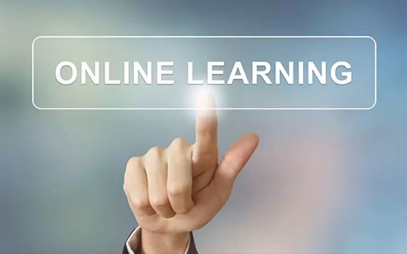A finger pressing a button labeled Online Learning