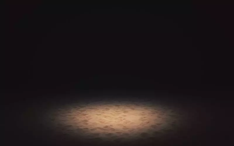 A single pool of light on a dark stage