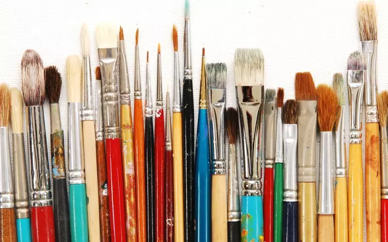 A row of paintbrushes in many colors