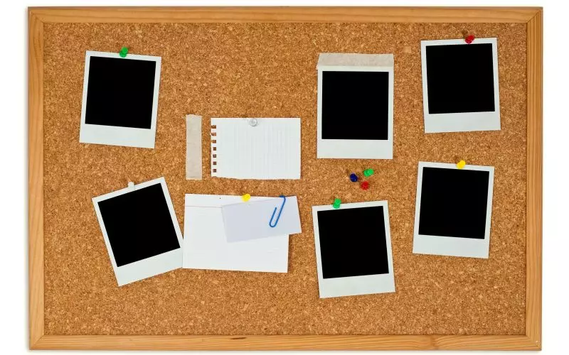 Instant photo frames and notes pinned to a cork board