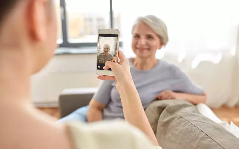 Someone looking at a phone on a sofa