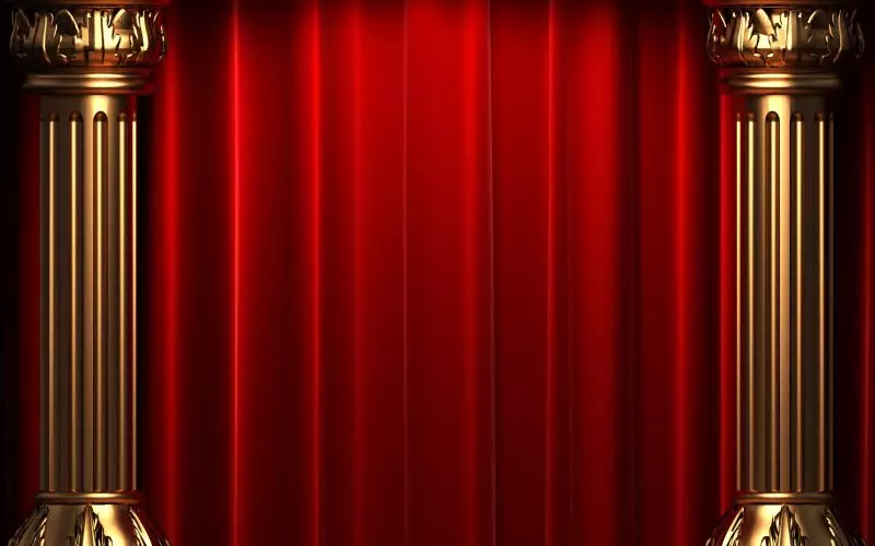 A red stage curtain framed by gold columns