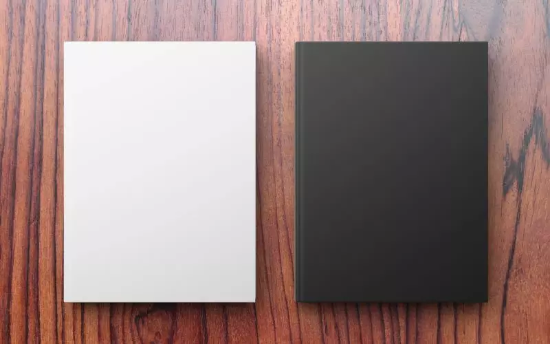 Two card designs side by side on wood