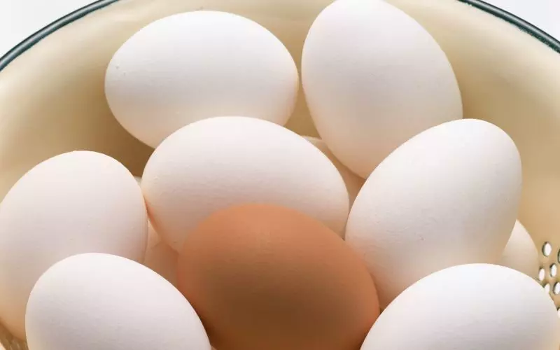 A bowl of white and brown eggs