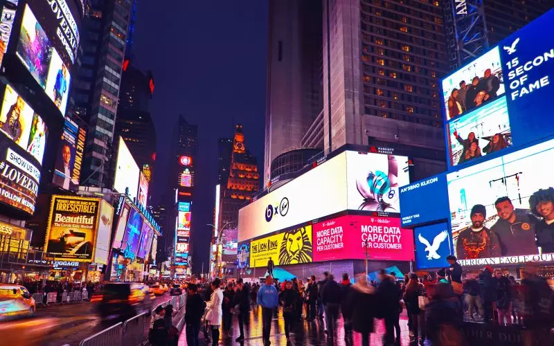 Times Square at night lit by advertising screens